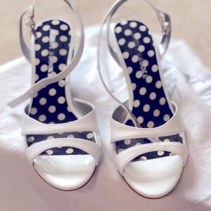 Pair of Audrey Brooke heeled sandals in white.